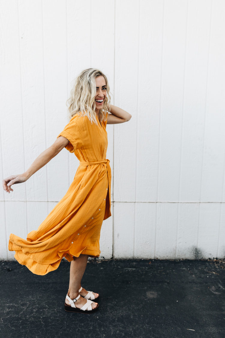 Girl in yellow dress and white sandals. 